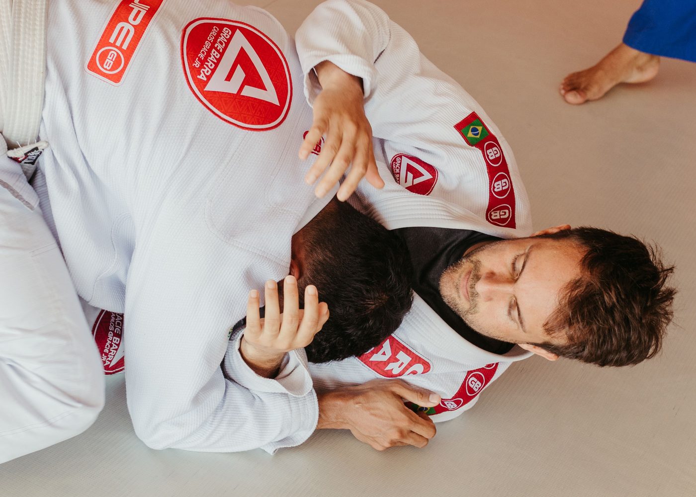 Two athletes grappling, seen from above
